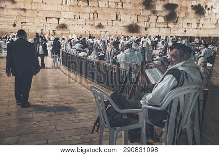 Religion Jew Reading Prayer Book. Torah On The Table In Front Of The Wailing Wall In The Old City Of