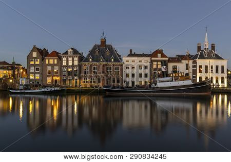 Maassluis, The Netherlands - February 26, 2019: The Harbor Of Maassluis With Old Boats, Tugs And Mon