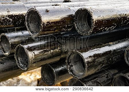 Oil Drill Pipe. Rusty Drill Pipes Were Drilled In The Well Section. Downhole Drilling Rig. Laying Th