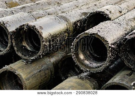 Oil Drill Pipe. Rusty Drill Pipes Were Drilled In The Well Section. Downhole Drilling Rig. Laying Th