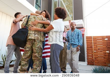 Three generation black family welcoming millennial male soldier returning home,low angle view