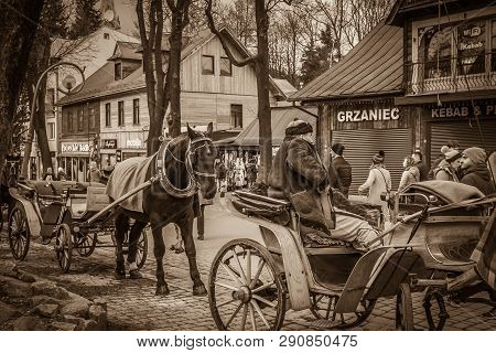 Zakopane, Poland - March 8, 2019: Old View Of Zakopane  Tradizional Mountain Village With Horses Wit