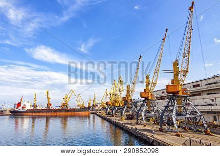 Lifting Cargo Cranes, Ship And Grain Dryer In Sea Port Of Odessa, Black Sea, Ukraine. Odessa Marine 