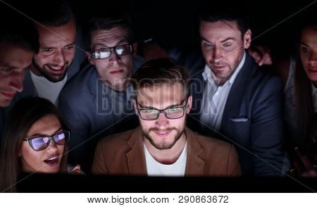 close up.a group of employees working in the office late