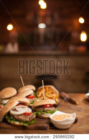 Food Composition Of Bugers Variety On A Wooden Table