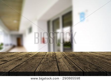 Wooden Brown Table Top Against The Blurred Corridor, Passage And Courtyard Of The House .for Product