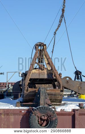 Old Port Crane. Rusty Bucket. Industrial Still-life