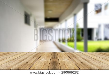 Wooden Brown Table Top Against The Blurred Corridor, Passage And Courtyard Of The House .for Product