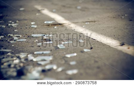 The Shards Of Automotive Glass In The Accident, Lying On The Pavement About Dividing The Solid Lines