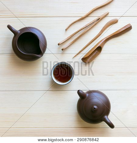Dishes For Tea And Wooden Sticks On A Light Background. A Set Accessories For The Tea Ceremony.