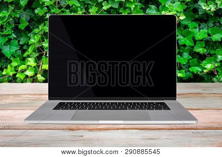 Green Eco-friendly Enviroment Template - Front View Of A Generic Modern Laptop With A Black Screen O