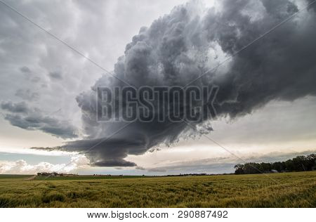 The Dying Updraft Of A Supercell Thunderstorm Creates A Strange Scene In The Sky Above A Windblown G