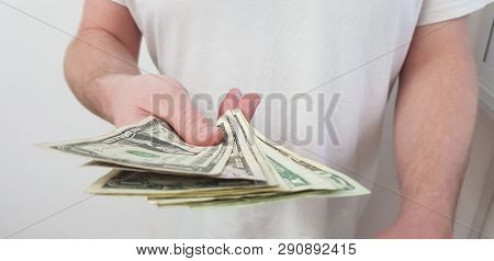 A Man Standing Wearing White Tshirt Holds In His Hand American Dollar Paper Banknotes