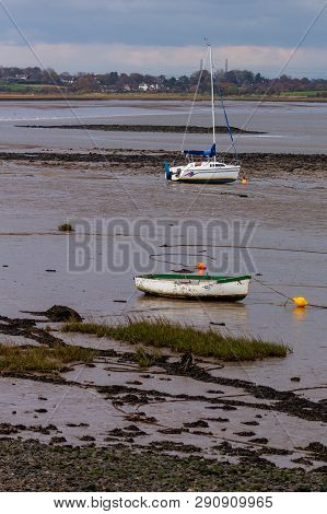 At Low Tide On The River Lune In Lancashire, England Boats Become Grounded In The Sand