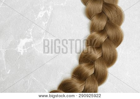 Braided Hair On Grey Background, Top View With Space For Text