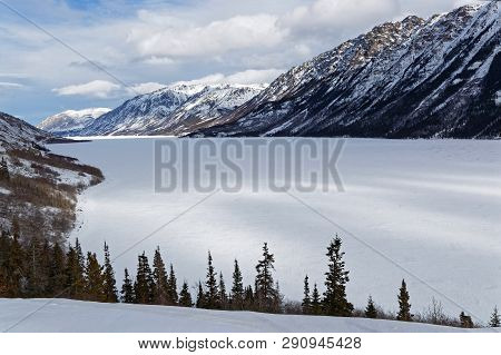 Frozen Tagish Lake, Surrounded By Moutains, Yukon