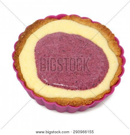 Blueberry Strawberry Cheesecake Tarte in sillicone backing cup over white.