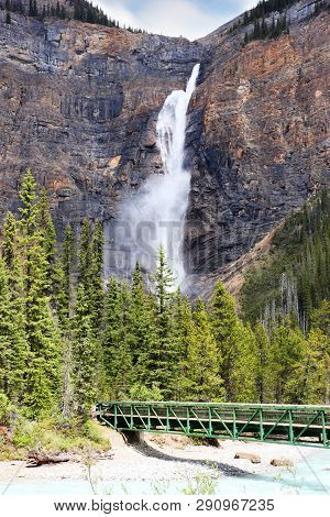 Footbridge Across Kicking Horse River To The Powerful Takakkaw Falls In Yoho National Park Near Fiel