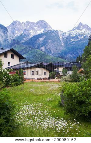 An Old, Vintage, Wooden House Is Located In The Alps