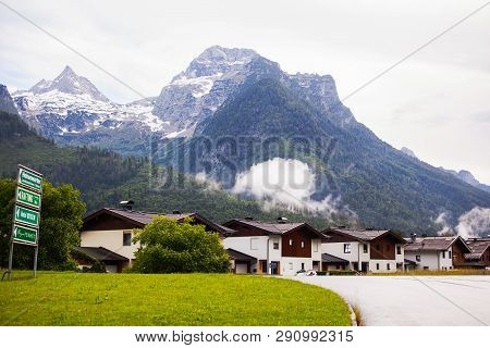 An Old, Vintage, Wooden House Is Located In The Alps