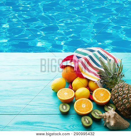 Citrus Fresh Food Near Swimming Pool. Summer Holidays. Orange, Kiwi, Pineapple, Lemon And Sea Shell 