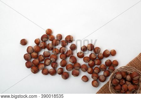 Nuts Scattered From The Corner On A White Background