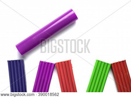 Different Colors Of Plasticine Lie On A White Board Next To A Gurney