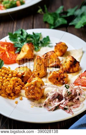 Light And Delicious Grilled Chicken Kebab, Located On A Platter With Tomato And Bulgur, Decorated Wi
