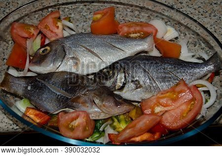 Baking Tray With Assorted Fish And Salad.