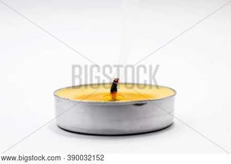 On A Light Background In The Center There Is A Yellow Extinguished Candle From The Wick Smoke Rises 