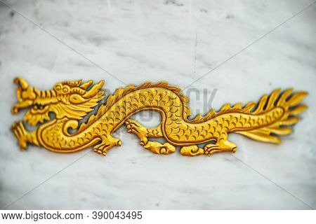 Selective Focus  Chinese Dragon, Golden Dragon, Gold Dragon On Marble Background