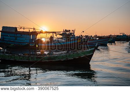 A Orange Beautiful Sunset Over Colorful Traditional Wooden Boats By The Fishing Society Village Chau