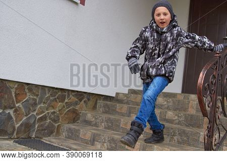 The Boy Goes Down The Stairs, Boy In Winter Makes A Big Step Down The Stairs