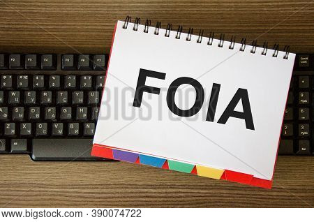 Focused On The Business Concept. The Word Foia Is Written On A White Piece Of Paper That Lies On The