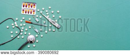 Pills, Ampoule, Syringes, Capsules, Stethoscope On The Green Doctor S Table. Copy Space. Place For T