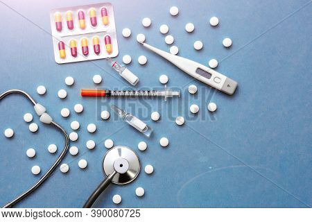 Pills, Ampoule, Syringes, Capsules, Stethoscope On The Blue Doctor S Table.