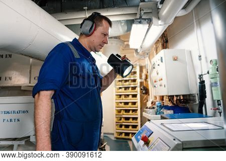Marine Engineer Officer Controlling Vessel Enginesand Propulsion In Engine Control Room Ecr
