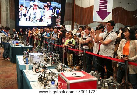 SUBANG JAYA - NOV 10: Unidentified visitors and supporters cheer their team on at the World Robot Olympaid on November 10, 2012 in Subang Jaya, Malaysia. This year's theme is Robots connecting people.