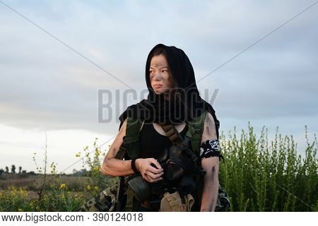 A Female Militia Soldier In A Post Apocalyptic Desert Wasteland. Urban Combat And Wasteland