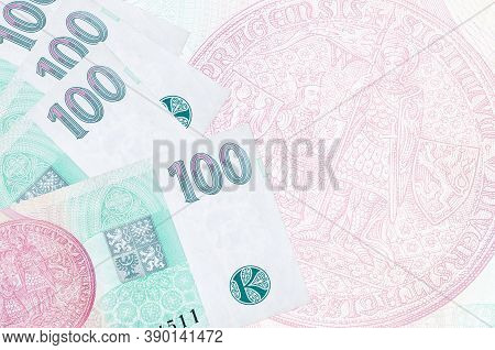 100 Czech Korun Bills Lies In Stack On Background Of Big Semi-transparent Banknote. Abstract Busines