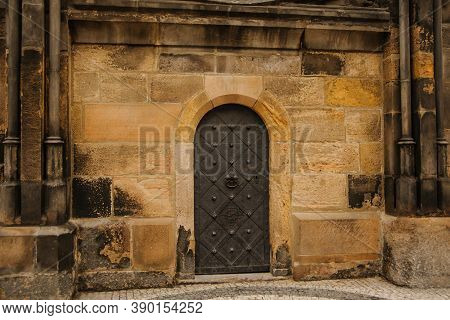 An Ancient Door Of A Castle In A City
