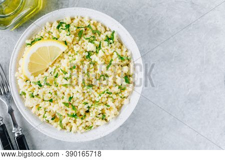 Lemon Herb Couscous In Bowl On Gray Background