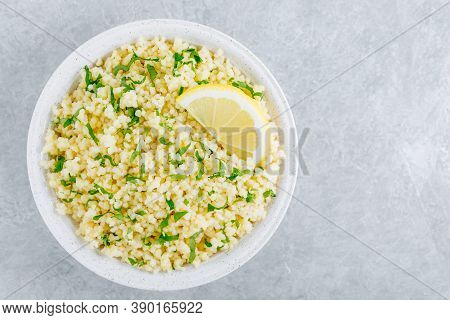 Lemon Herb Couscous In Bowl On Gray Background