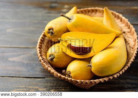 Eggfruit Or Canistel In A Basket On Wooden Table, Thai Fruit, In Thai Names Such As Xiantao, Lamut K