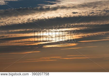 The Setting Sun Obscured By Light Clouds And Heavy Smoke From A Nearby Forest Fire Create An Orange 