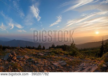 Layers Of Smoke From A Nearby Wildfire Give An Orange Glow To The Setting Sun Over The Cascade Mount