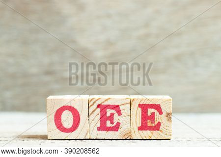 Alphabet Letter Block In Word Oee (abbreviation Of Overall Equipment Effectiveness) On Wood Backgrou