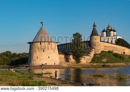 Pskov, Russia: August 21, 2020: Pskov Kremlin View From River Pskova Creek. Towers, Wall And Trinity