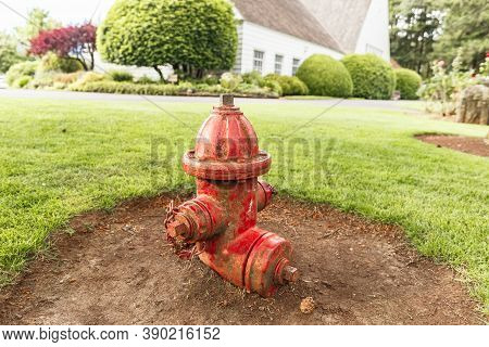 Cascade Locks, Oregon - June 26, 2018: Red Old Shabby Fire Hydrant On A Lawn In Bonneville Fish Hatc