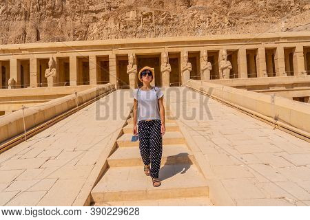 A Young Woman On The Entrance Stairs To The Funerary Temple Of Hatshepsut In Luxor. Egypt